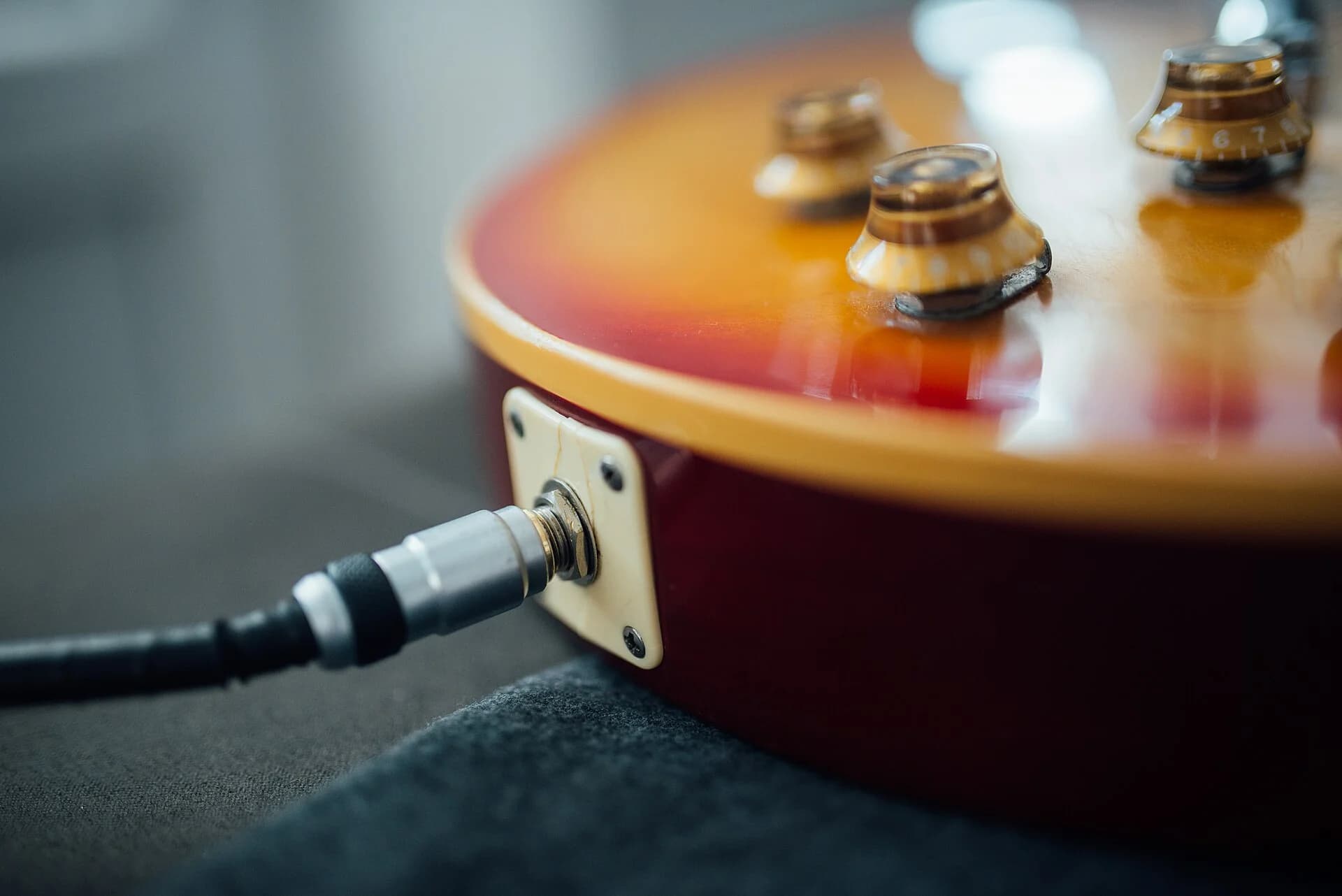 A cable plugged into the output jack of an electric guitar. Photo: Shixart1985, CC BY 2.0